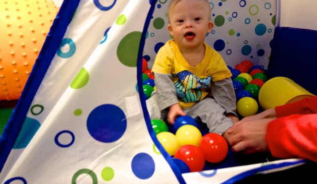 baby playing in ball pit special needs