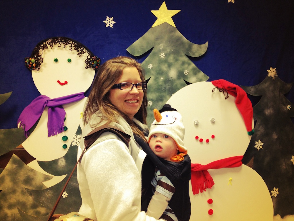 baby wearing snowman hat in carrier mom down syndrome