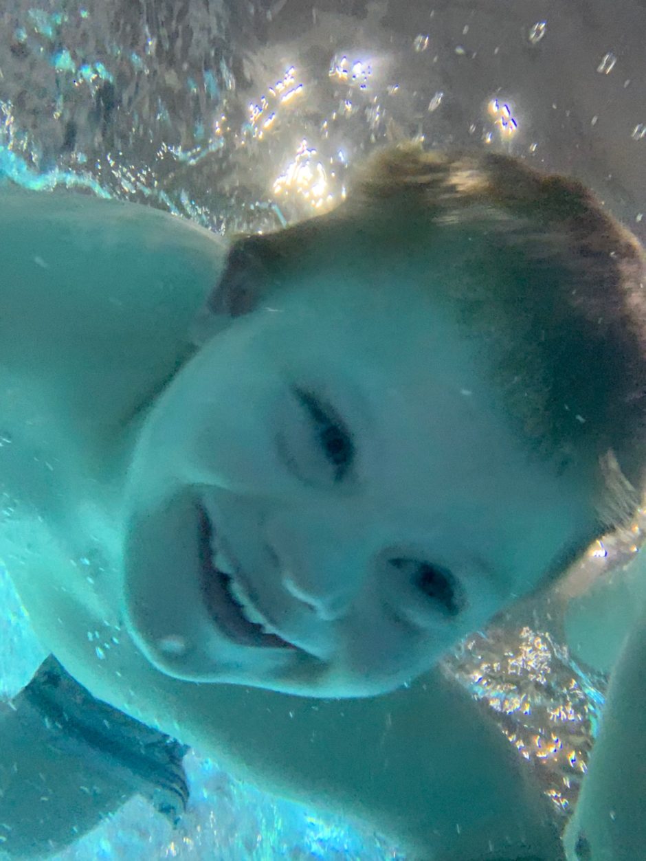 great wolf lodge child with down syndrome under water iPhone picture 