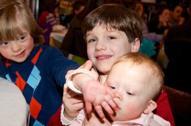 baby with down syndrome playing with fingers