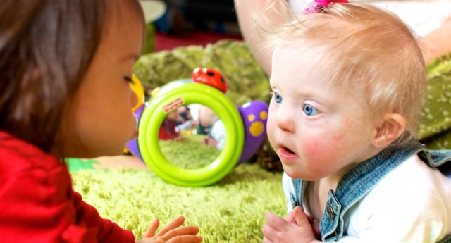 down syndrome girls toddlers crawling friends