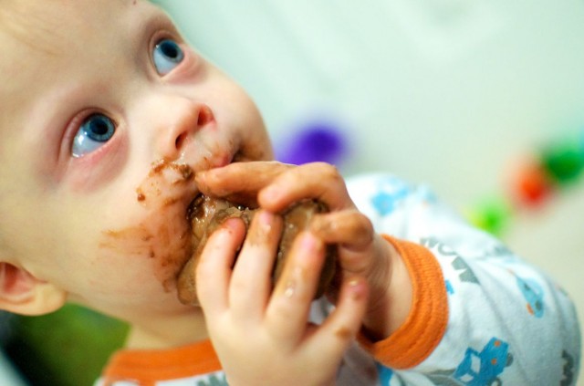 messy baby eating chocolate bar