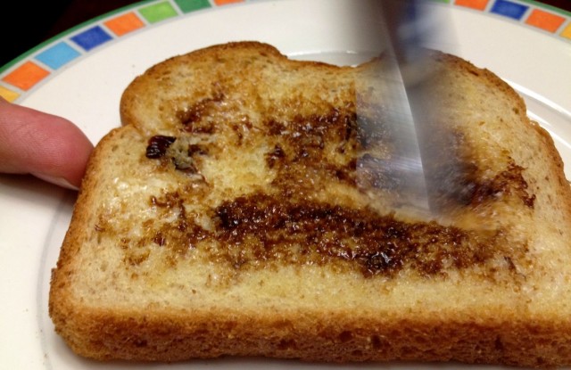 spreading vegemite toast child baby