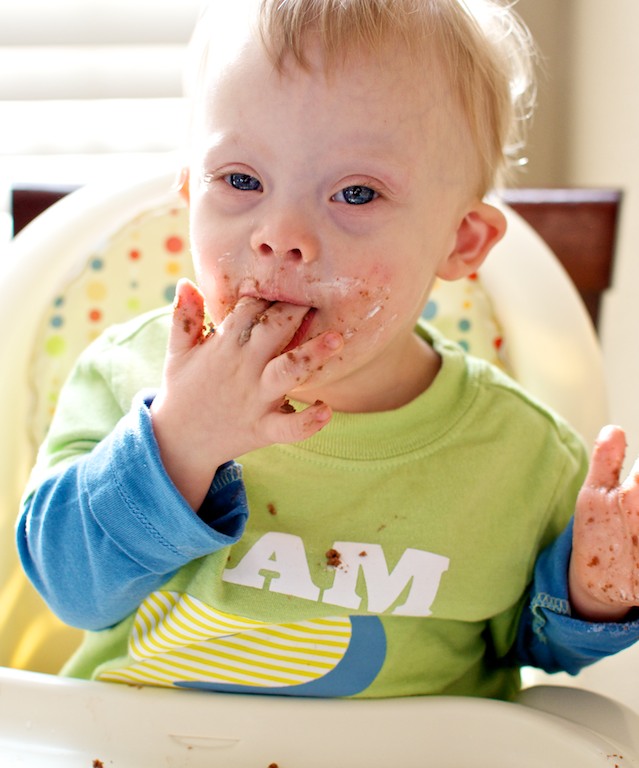 baby down syndrome eating birthday cake