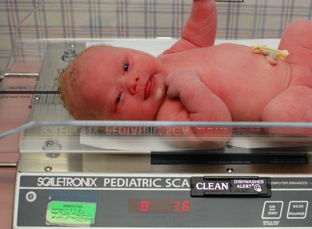 our new born son with down syndrome on the scale