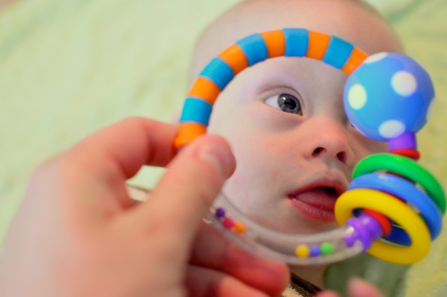 Our son with down syndrome playing with toys.