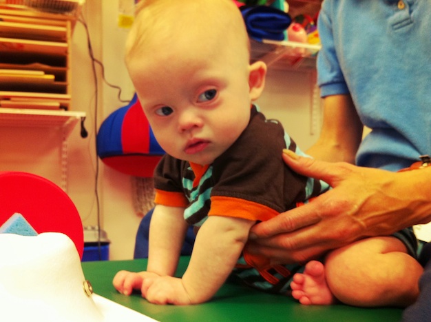 our baby who was born with down syndrome at physical therapy 
