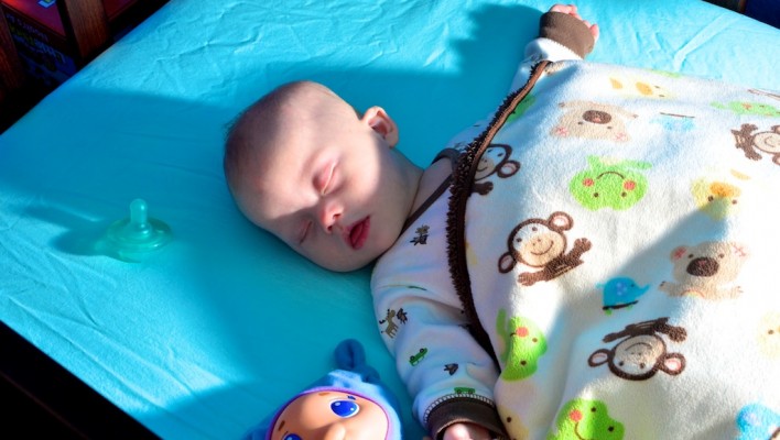 baby with down syndrome sleeping peacefully in crib