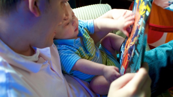 Dad reading first dc comic jla justice league to his son