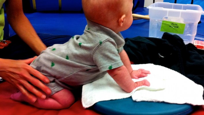 boy with down syndrome exercising at physical therapy