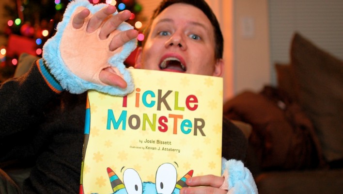 dad reading tickle monster to his son born with down syndrome