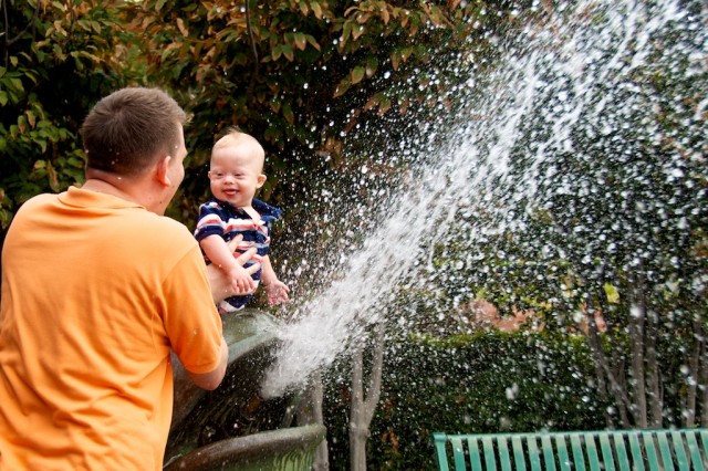 father and son down syndrome playing water