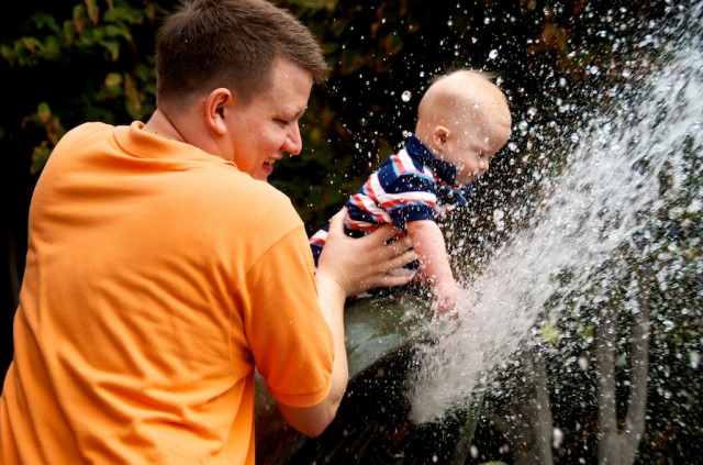 father son baby down syndrome playing in water