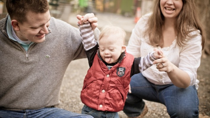 cute fun family playing with their child