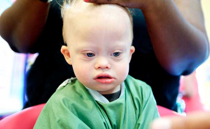 down syndrome child getting haircut special needs