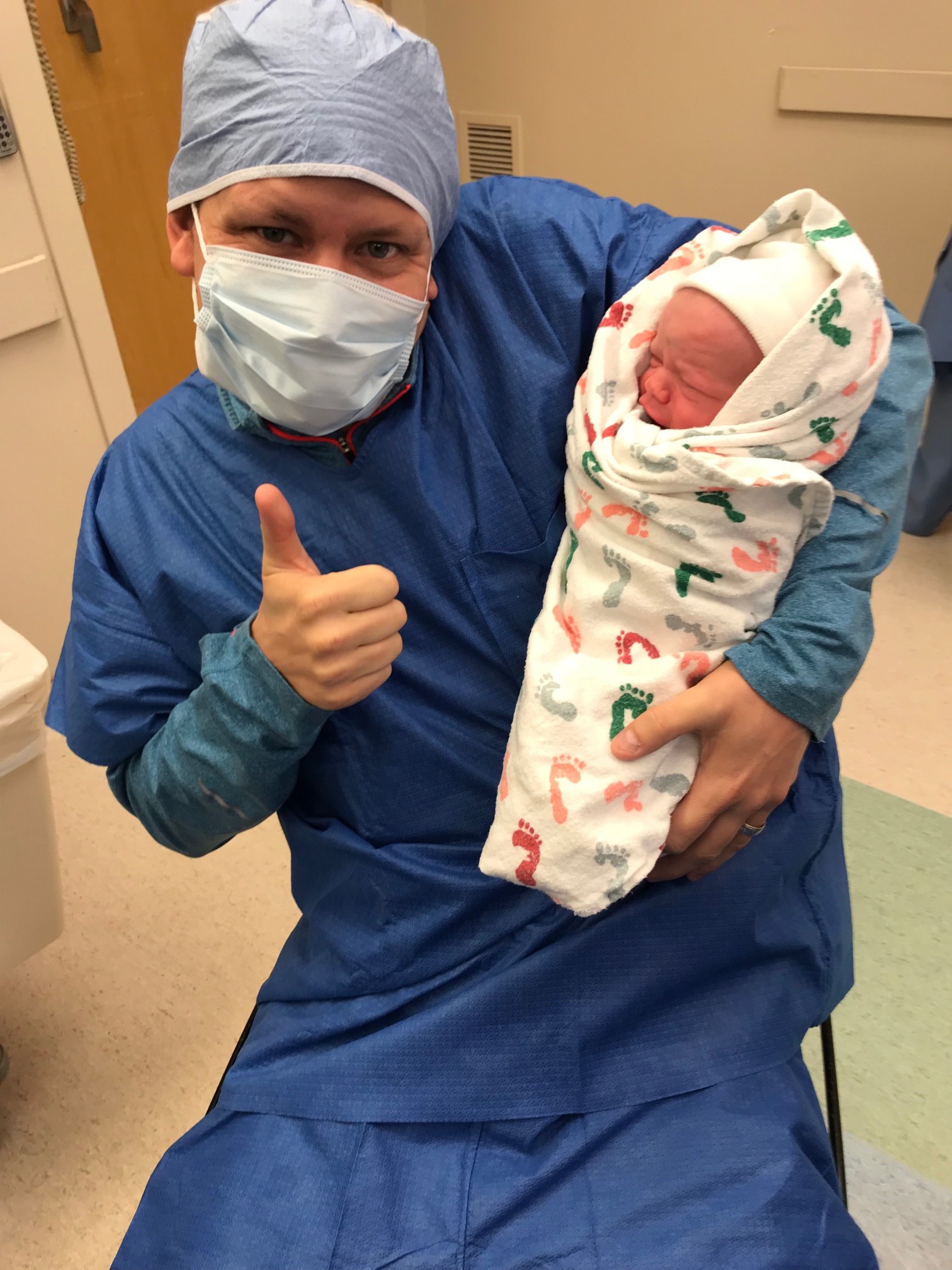 father with newborn son in the delivery room